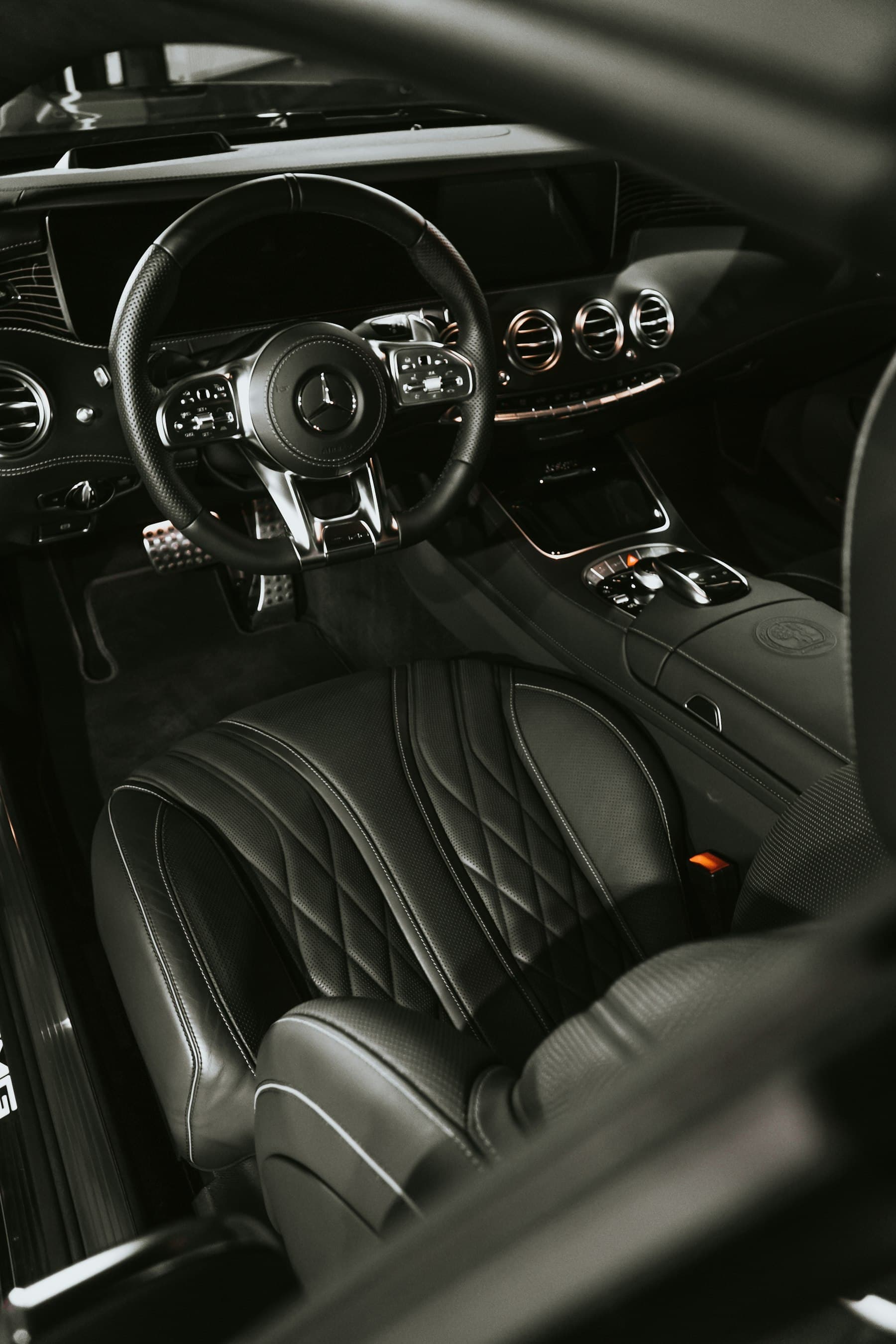Clean black quilted leather seats inside a car